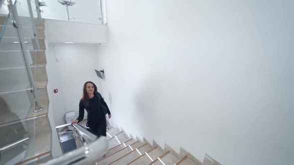 Woman Walking Up Stairs