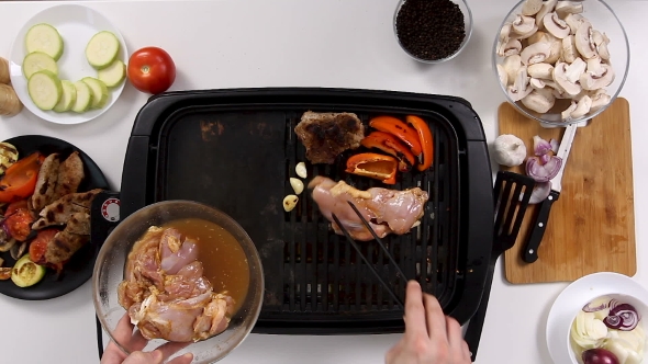 Cook Places Boneless Chicken Meat on Grill