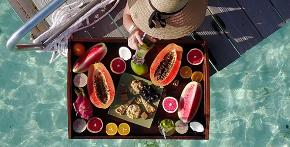 Woman Eating from Beautiful Fruit Tray in Bikini on Tropical Island