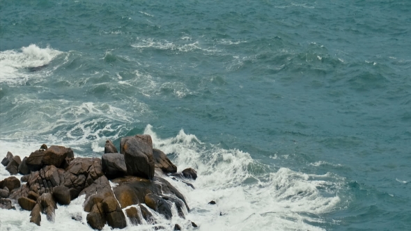 Powerful Ocean Waves Breaking on a Rocky Shore During a Storm