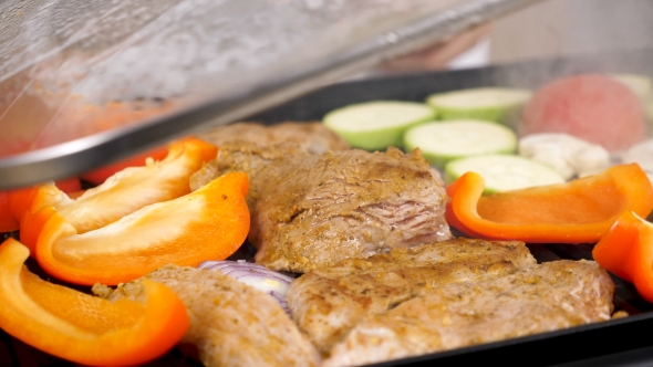 Steaming Vegetables and Meat on a Grill