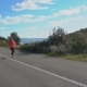 Outdoor Shot of Fitness Woman Running on Open Country Road - VideoHive Item for Sale