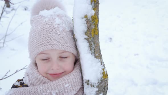 Child By Snowy Tree