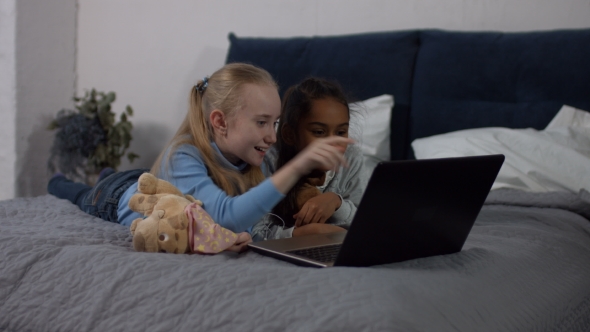 Happy Multiracial Girls Enjoying Cartoons on Laptop alt