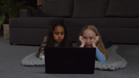 Joyful Girls Watching Comedy Show Online on Laptop alt