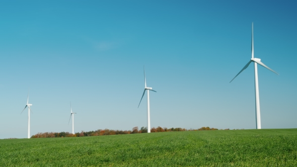 Several Wind Turbines on a Green Hill