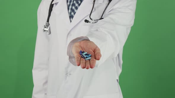 Medical Worker Holding Out Pills To the Camera