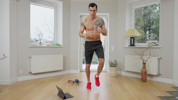 Wide Shot of Focused Confident Concentrated Sportsman Running in Place at Home