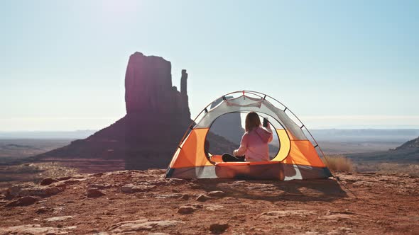 Camping Woman in Bright Tent Taking Photo Beautiful Monument Valley 5G Connect