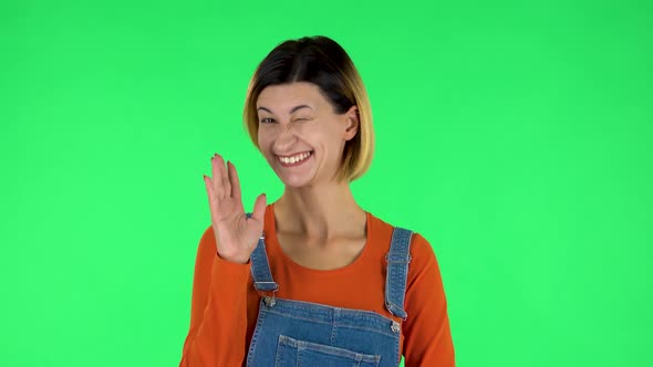 Lovely Girl Coquettishly Smiling, Waving Hand and Showing Gesture Come Here. Green Screen