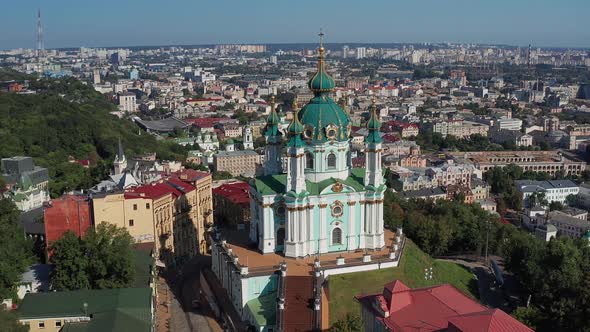 Beautiful flight over St. Andrew's Church in Kiev. Top view of Podol. Many buildings and churches.