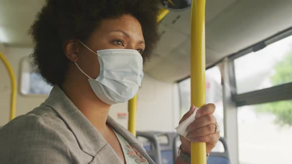 Plus size biracial woman wearing face mask in bus