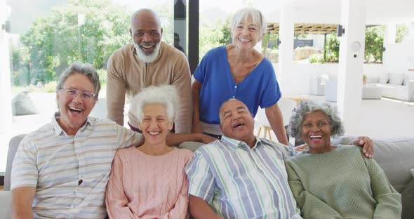 Portrait of senior diverse people embracing at retirement home