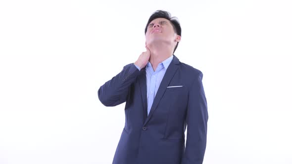 Stressed Young Asian Businessman Having Neck Pain
