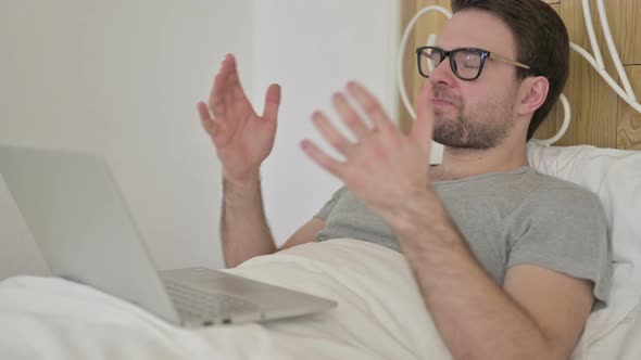 Upset Beard Young Man Get Shock on Laptop in Bed