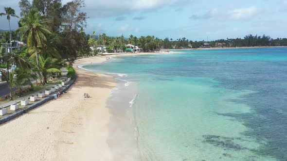 Turquoise seawater and seashore of Playa Punta Popy, Las Terrenas in Dominican Republic. Aerial dron