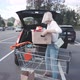 Anonymous Blonde Woman Loading Groceries Into Trunk of Car - VideoHive Item for Sale