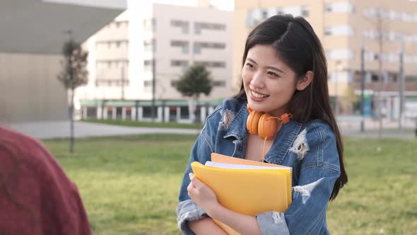 University students talking and having fun together after having classes together