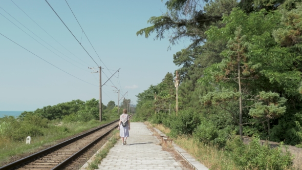 Young Girl Walks on the Railway