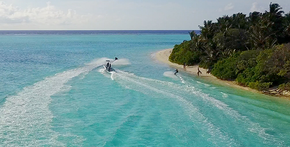 Jetskiing in Tropical Ocean Next to Beautiful Small Island in The Maldives