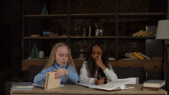 Multiethnic School Girls Studying Together at Home