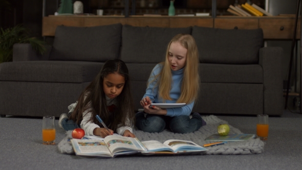 Positive Diverse Girls Doing Homework Together