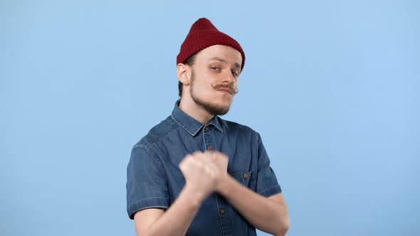 Portrait of Bully Guy with Curly Mustache Wearing Hat Fistfighting and Prepairing for Punch Isolated