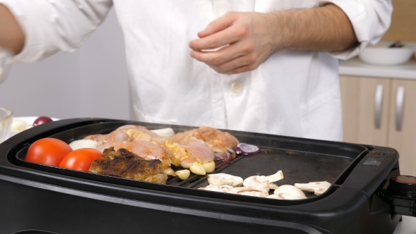 Mushrooms Getting Placed on the Grill