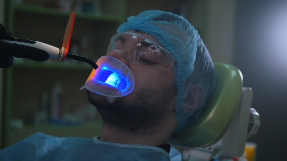 Doctor and Patient with Lip Dilator in the Dental Office, Cleaning and Disinfection with Ultraviolet