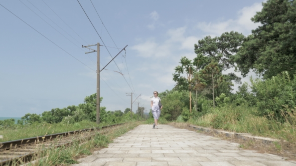 Young Girl Walks on the Railway Station. Georgia