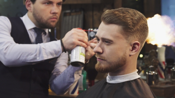 Handsome Bearded Man Getting Fire Hair Treatment at the Barbershop