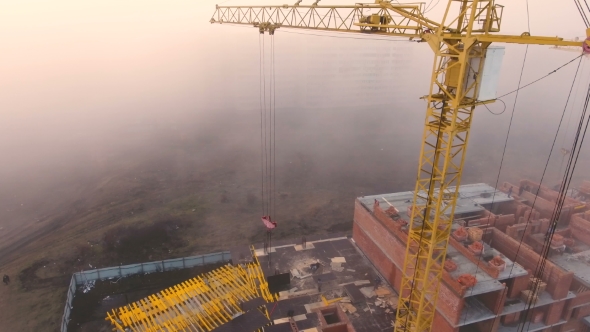 Construction Site in the Fog with a Bird's Eye with Tower Cranes on the Sunset.
