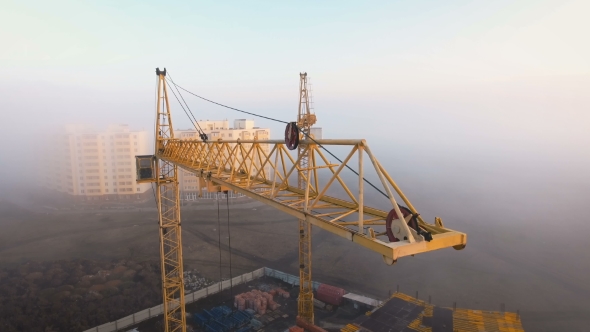 Construction Site in the Fog with a Bird's Eye with Tower Cranes on the Sunset