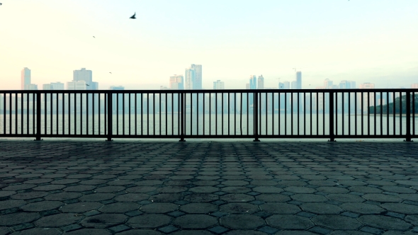 Landscape with the Tile and Fance at Quay and the Seaside Skyscrapers