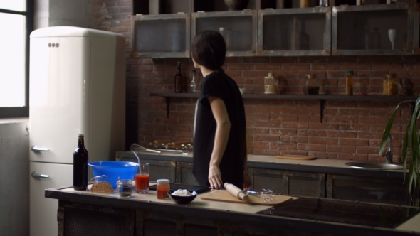 Lovely Woman in Kitchen Following Recipe on Tablet