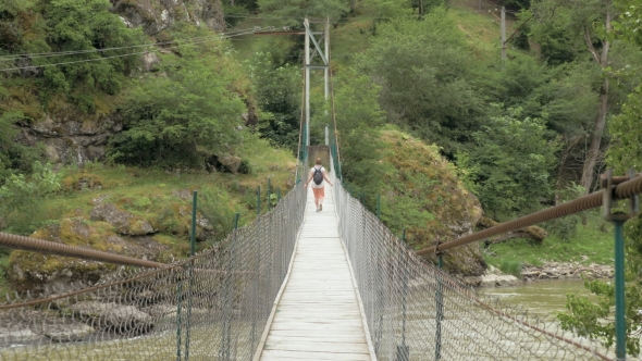 Young Girl Walks on the Suspension Bridge - Georgia