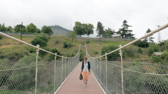 Young Girl Walks on the Suspension Bridge - Georgia