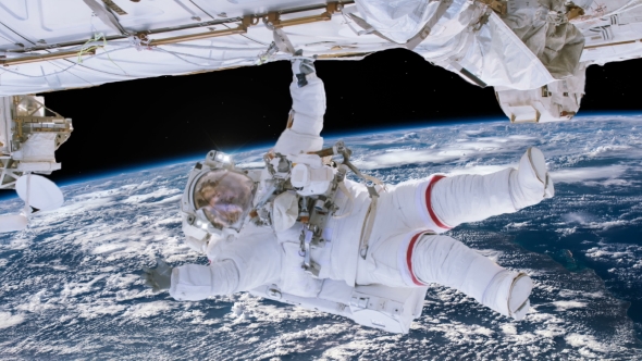 Astronaut Working on Space Station Above the Earth alt