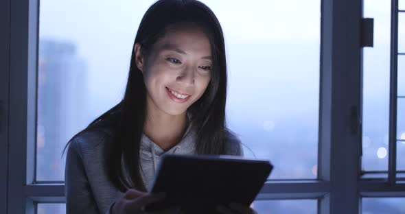 Woman Use of Tablet Computer at Night