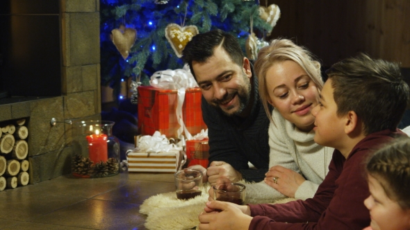 Young Happy Family Relaxing on a Shaggy Rug