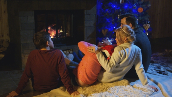 Family Spending Time at Fireplace in Christmas