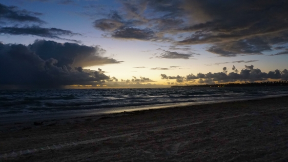 Dramatic Sunset Over Ocean Waves. Clouds