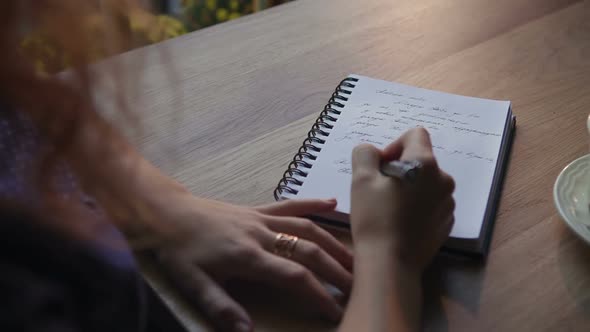 Close Up Woman Writing on Notebook