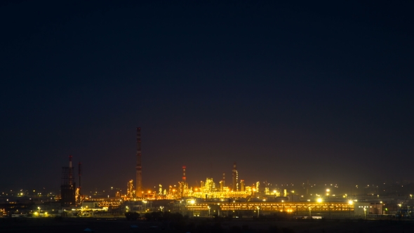 View of a Glowing Refinery at Night
