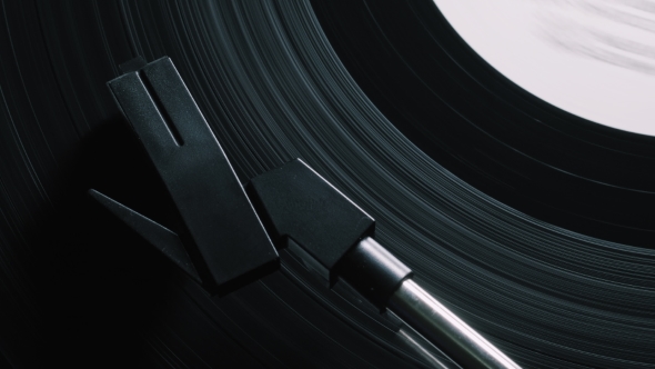Vinyl Record on Turntable, Viewed From Above. Pick-up Lifts Off