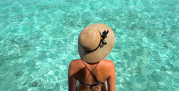 Girl in Bikini Sitting Above Incredible Blue Tropical Water in the Maldives