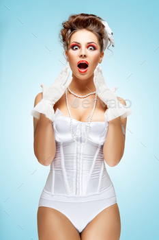 ith stylish makeup in a vintage corset showing strong emotions.