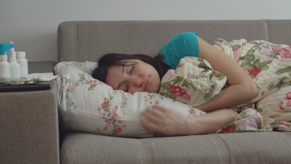 Young Woman Lying on Bed with Common Cold