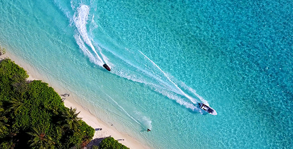 Aerial Shot of Watersports Alongside Incredibly Pristine Tropical Island