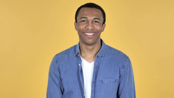 Smiling Young African Man Yellow Background